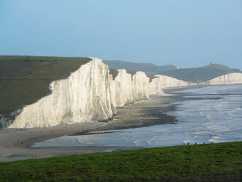 Scenic view of beach against clear blue sky