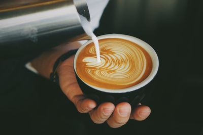 Close-up of hands making coffee