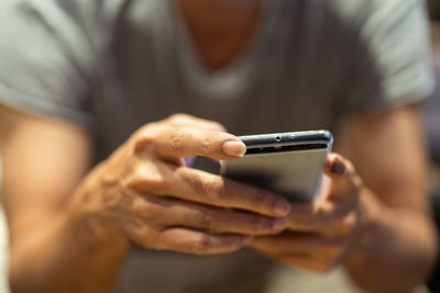 Close-up of hand holding mobile phone