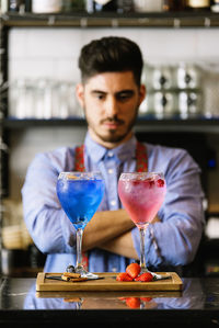 Bartender with drinks in bar