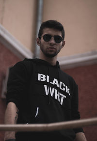 Young man wearing sunglasses standing outdoors