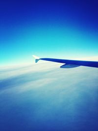Cropped image of airplane flying over sea