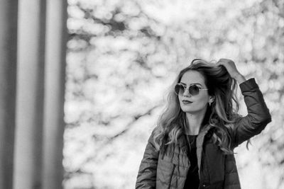 Beautiful woman standing against columns