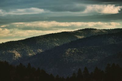 Idyllic shot of mountains against cloudy sky