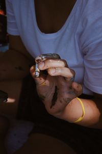 Midsection of woman holding cigarette