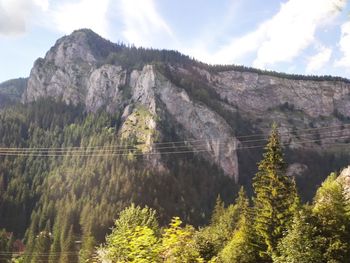 Scenic view of mountains against cloudy sky