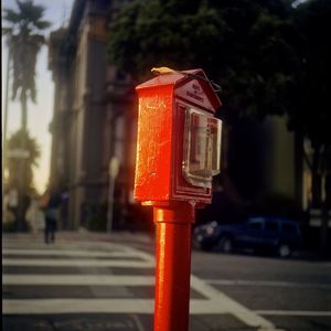 Close-up of red telephone booth on street