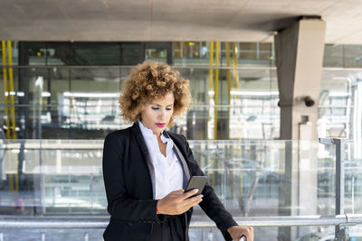 Stewardess in working uniform using her smartphone