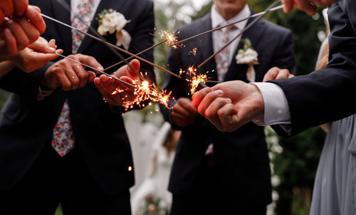 Midsection of bride holding bouquet