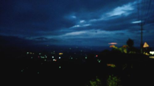 Defocused image of illuminated city at night