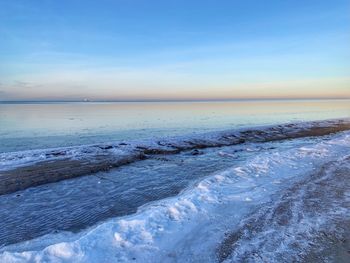 Scenic view of sea against sky during winter