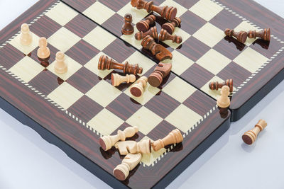 High angle view of chess board over white background