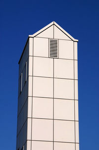 Low angle view of building against clear blue sky