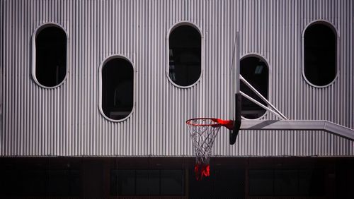 Basketball hoop with contemporary design architecture background contrast.