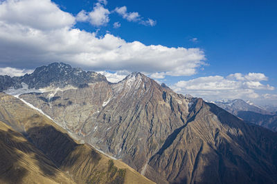 Scenic view of mountain range against cloudy sky