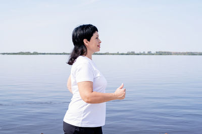 Side view of man standing in lake