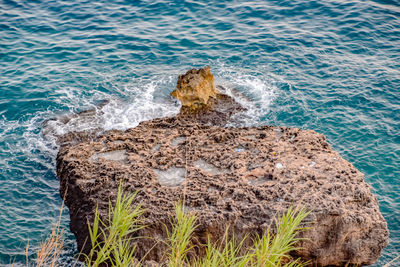 High angle view of rocks in sea