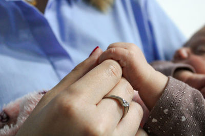 Close-up of couple holding hands