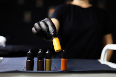 Close-up of hand holding bottles