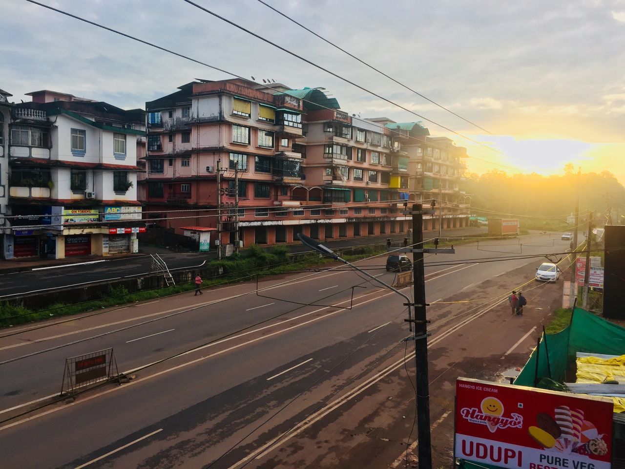 VIEW OF CITY STREET AND BUILDINGS AGAINST SKY