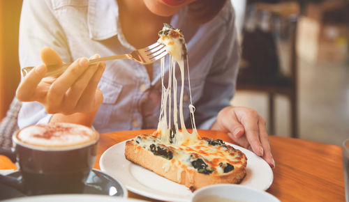 Close-up of woman having pizza