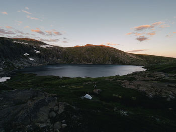 Scenic view of lake against sky at sunset