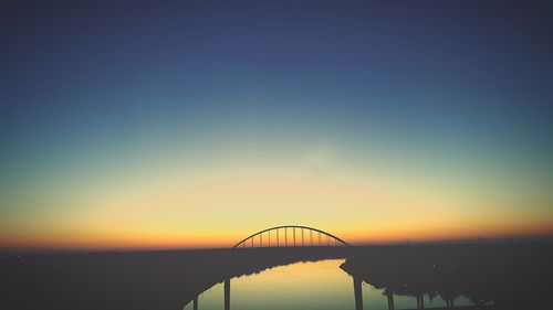 Silhouette st georges bridge against sky during sunset