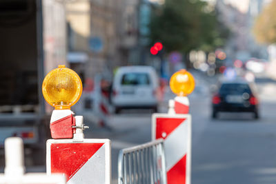 Close-up of traffic sign on road in city