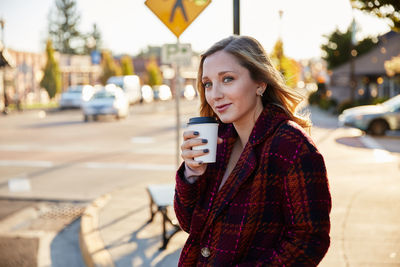 Portrait of young woman holding drink