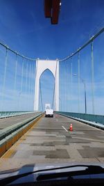 Bridge against sky seen through car windshield