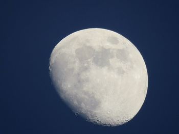 Low angle view of moon against clear blue sky