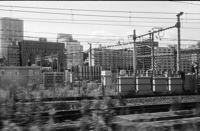 Construction site by buildings in city against sky