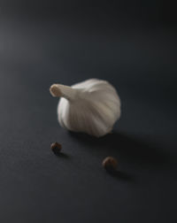 Close-up of garlic on table against black background