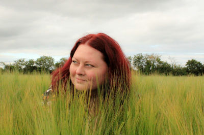 Portrait of smiling young woman on field