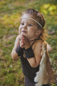Cute baby dressed in the clothes of primitive people