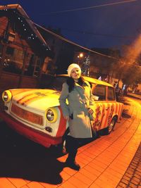 Woman on illuminated street at night