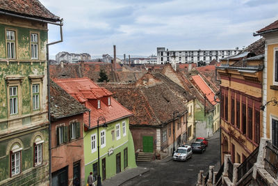 View of cityscape against cloudy sky