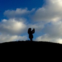 Silhouette man on landscape against sky