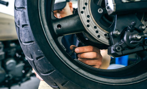 Mechanic with motorcycle at garage