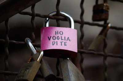 Close-up of padlocks hanging on railing