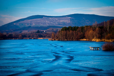 Scenic view of lake and mountains against sky