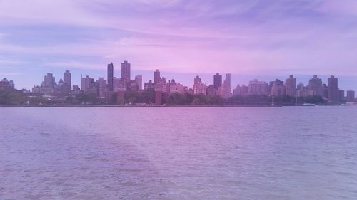 Cityscape against cloudy sky