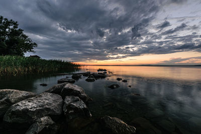 Scenic view of lake against sky during sunset