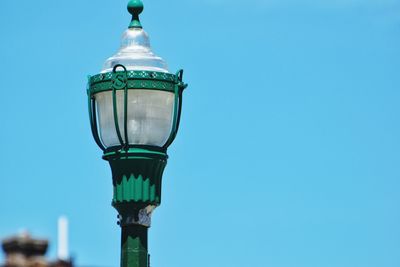 Low angle view of street light against blue sky