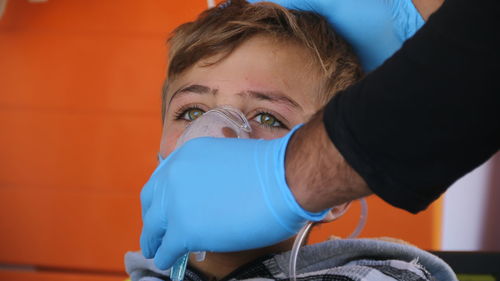 Close-up of doctor hand assisting kid at hospital