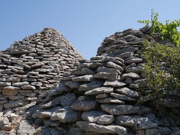 Low angle view of stone stack against sky