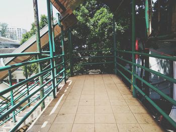 Empty footpath amidst buildings in city