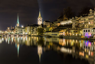 Reflection of illuminated buildings in city at night