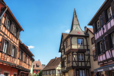 Small colorful german half timbered houses in kaysersberg along the main street. 