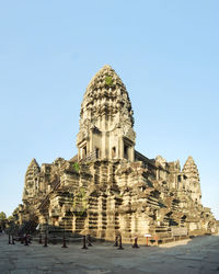 Group of people in temple against clear sky